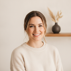 Portrait of Jessica Lane, a North American woman, smiling and looking at the camera, with a clean, soft background.