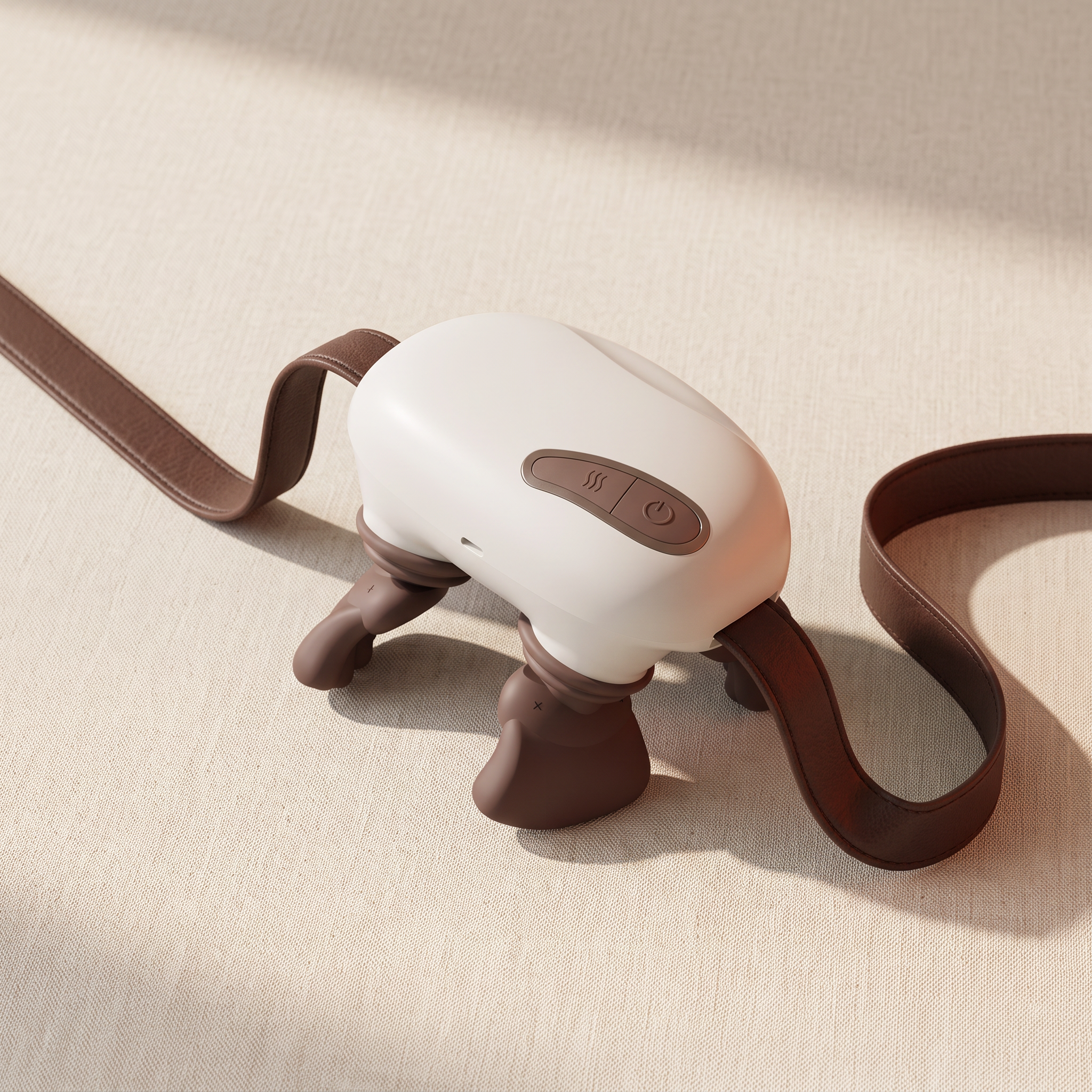 Compact bionic-hand neck and shoulder massager with silicone thumb nubs and leather straps on a cream studio backdrop