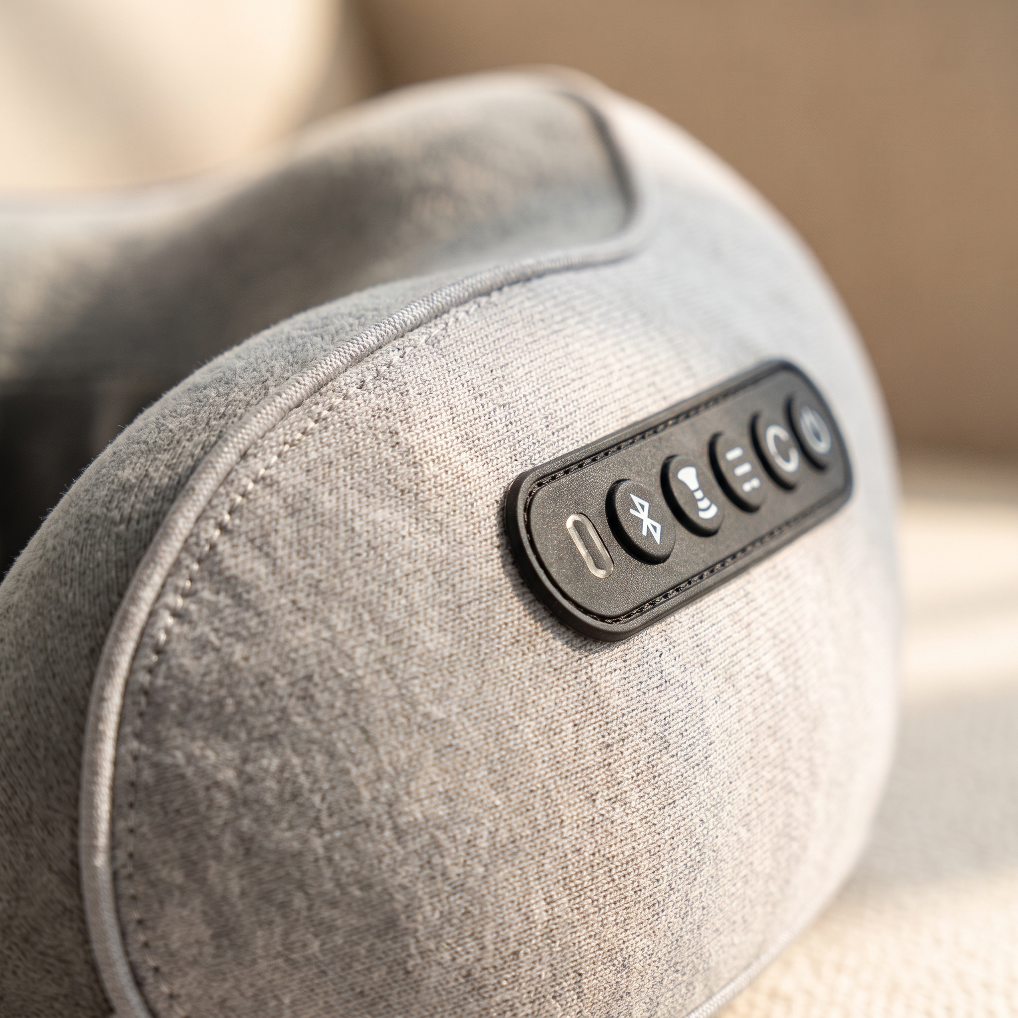 Close-up of the control buttons and soft cotton fabric of the U-shaped neck pillow